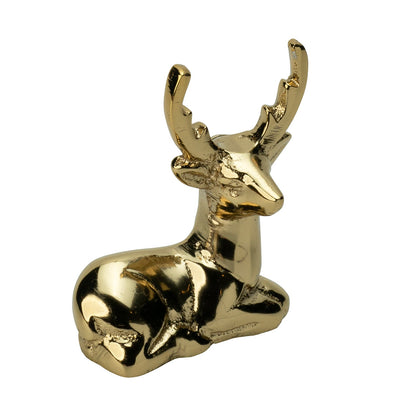 Blitzen Reindeer Placecard Holder, Gold, A small brass reindeer figure in a gold finish, lying down with its antlers raised.