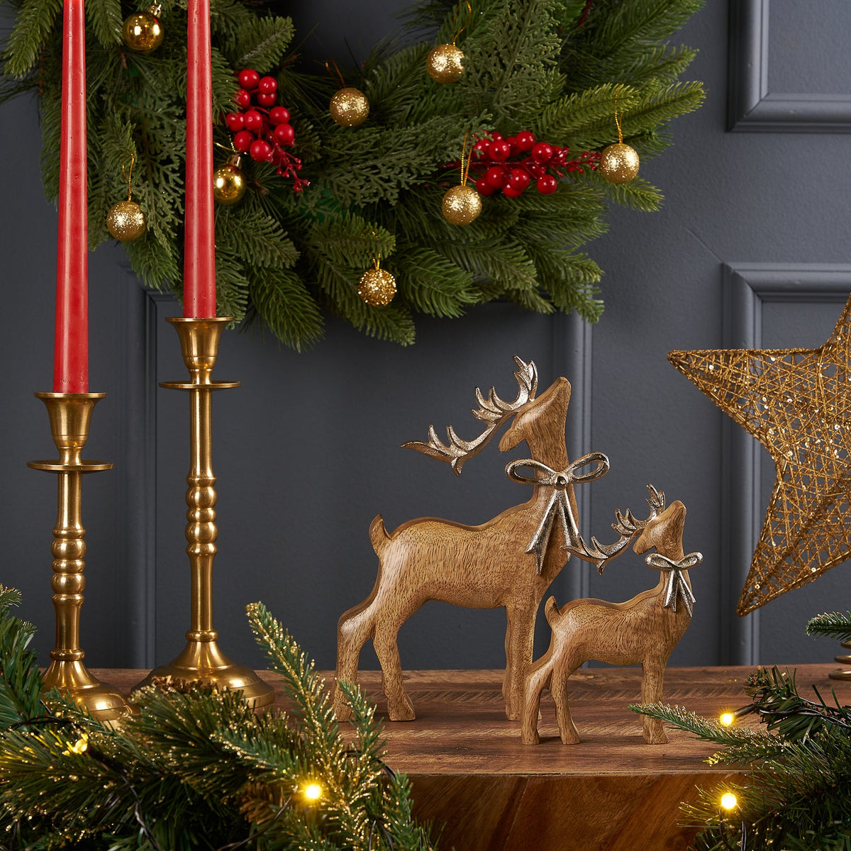 Rudolph Wooden Reindeer, the Small and Large sizes side by side on a holiday mantel