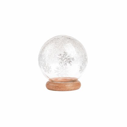 Adonis Snow Globe, A clear, crackled glass snow globe patterned with white snowflakes, set on a round natural wood base.