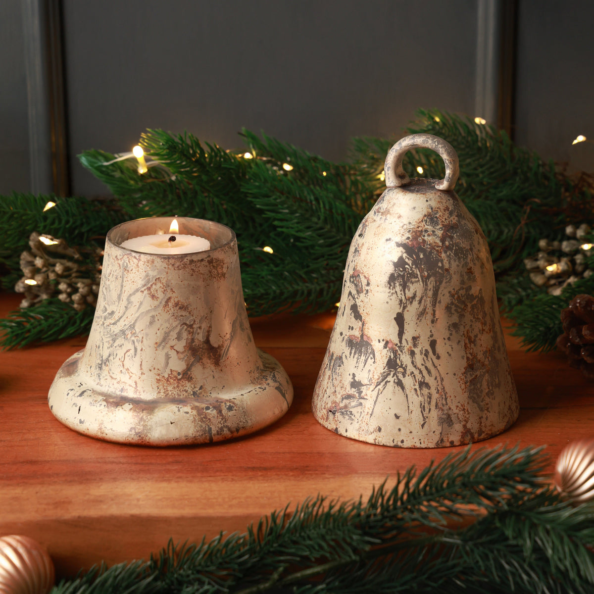 Russet Glass Bell Candle Holder, A copper gold glass bell shaped candle holder with a mottled metallic finish and a ring on top, shown separated into its bell top and matching base.
