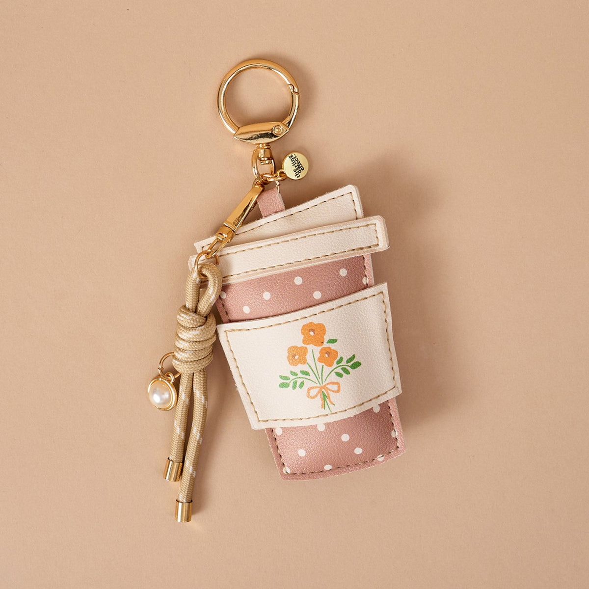 Vegan Leather Bag Charm, A dog shaped bag charm in cognac vegan leather with floppy ears, a small collar tag, and a burgundy cord tassel with a pearl bead.