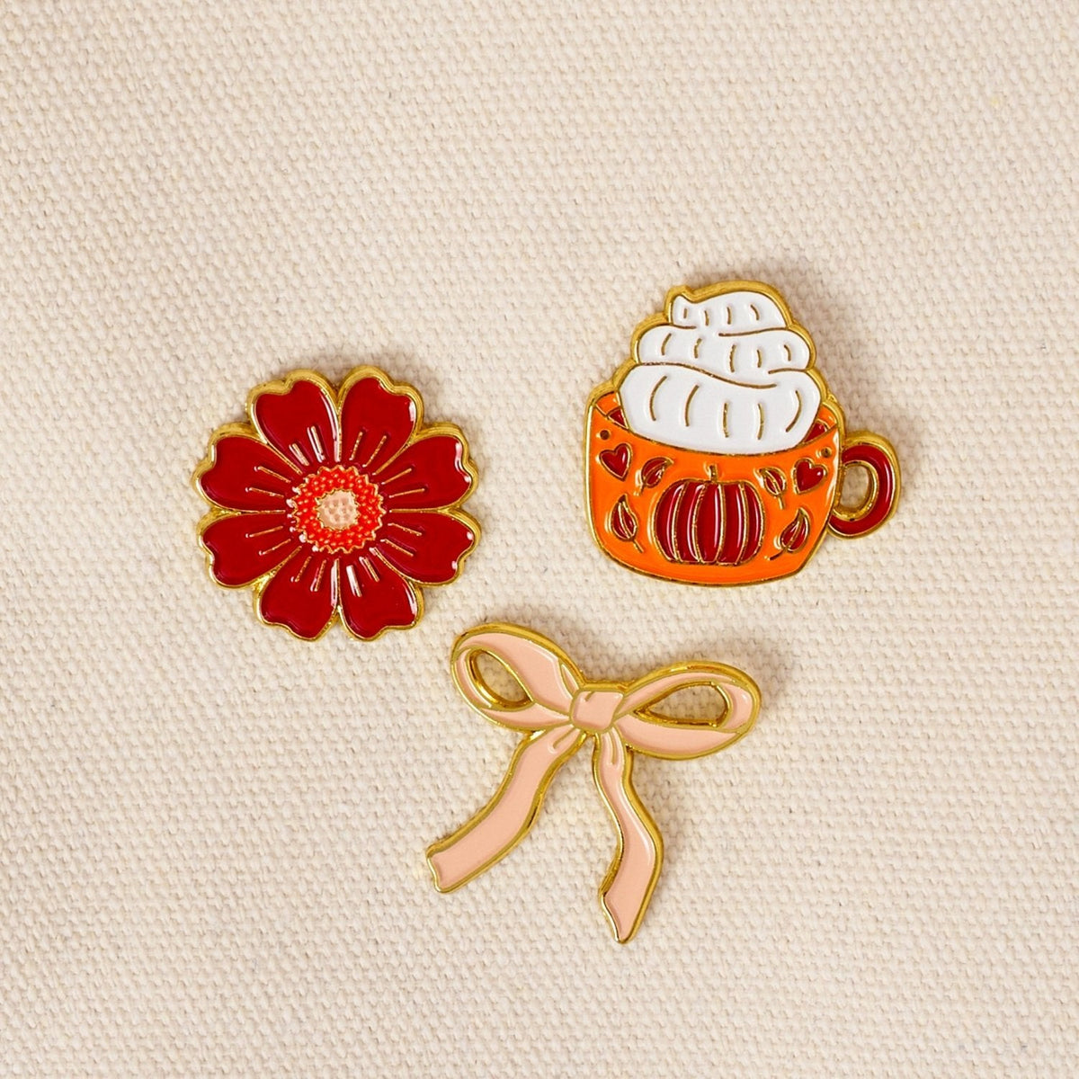 Enamel Pin Pack, A boxed set of three gold enamel pins in the Latte Love design, a coffee cup, a teddy bear, and a pink bow.