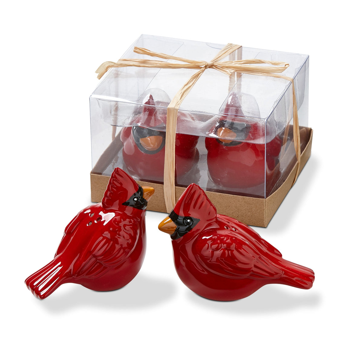 Cardinal Salt and Pepper Shakers, Two glossy red ceramic-look cardinal figurines with black masked faces and orange beaks, sitting in front of a clear box tied with a raffia bow.