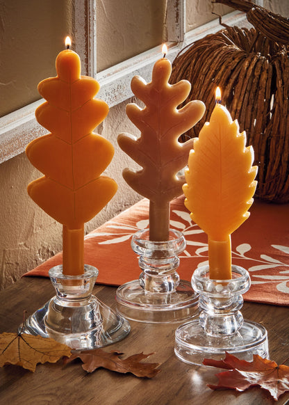 Fall Leaf Taper Set of Three, Photo shows three taper candles shaped like leaves in orange, brown, and gold, each with a raised vein pattern.