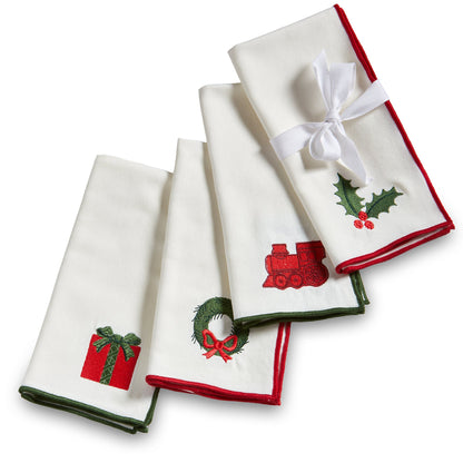 Christmastime Embroidered Napkin Set of Four, Photo shows four white napkins folded together, each embroidered with a different Christmas icon and trimmed in red or green satin.