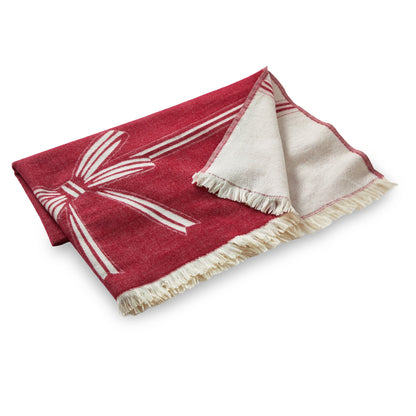Bow Reversible Throw, A folded red and cream reversible throw blanket with a woven bow design and fringed edges.