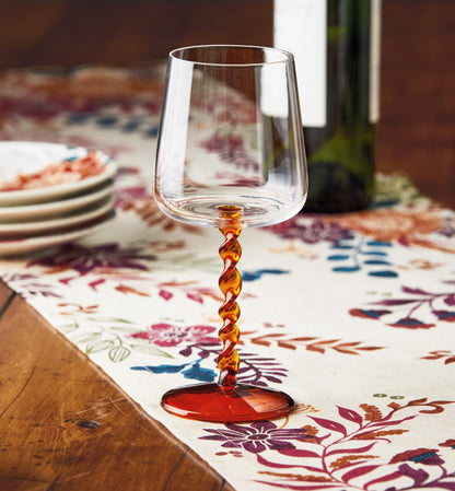 Twist All Purpose Wine Glass, Photo shows an all purpose wine glass with a clear bowl, an amber twisted stem, and a matching amber round base.