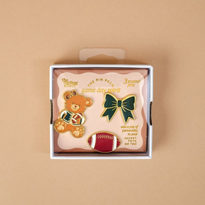 Enamel Pin Pack, A boxed set of three gold enamel pins in the Latte Love design, a coffee cup, a teddy bear, and a pink bow.