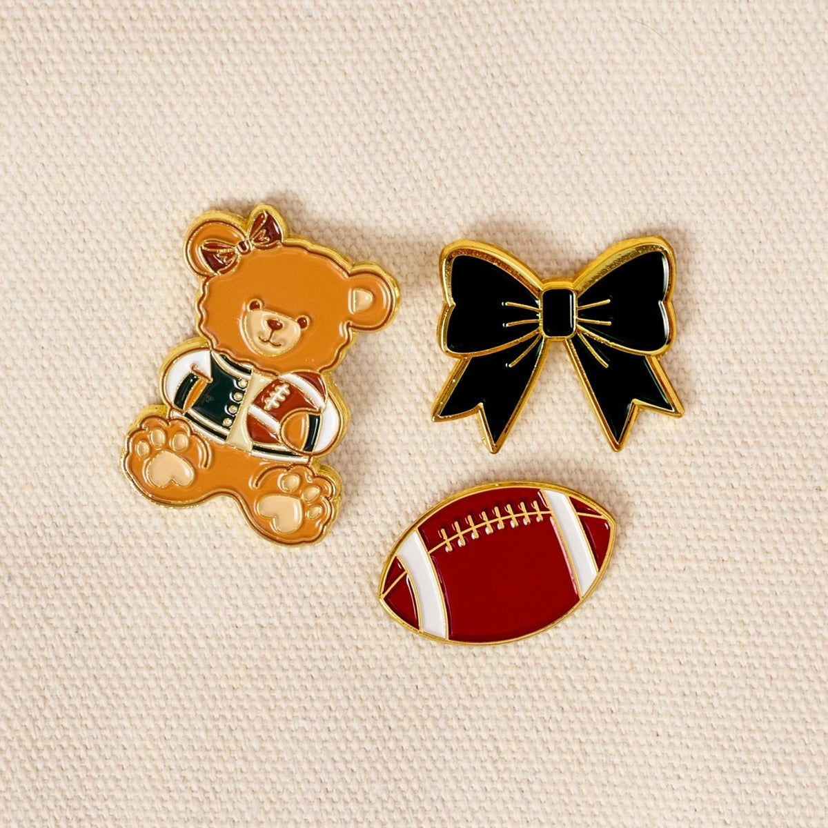 Enamel Pin Pack, A boxed set of three gold enamel pins in the Latte Love design, a coffee cup, a teddy bear, and a pink bow.