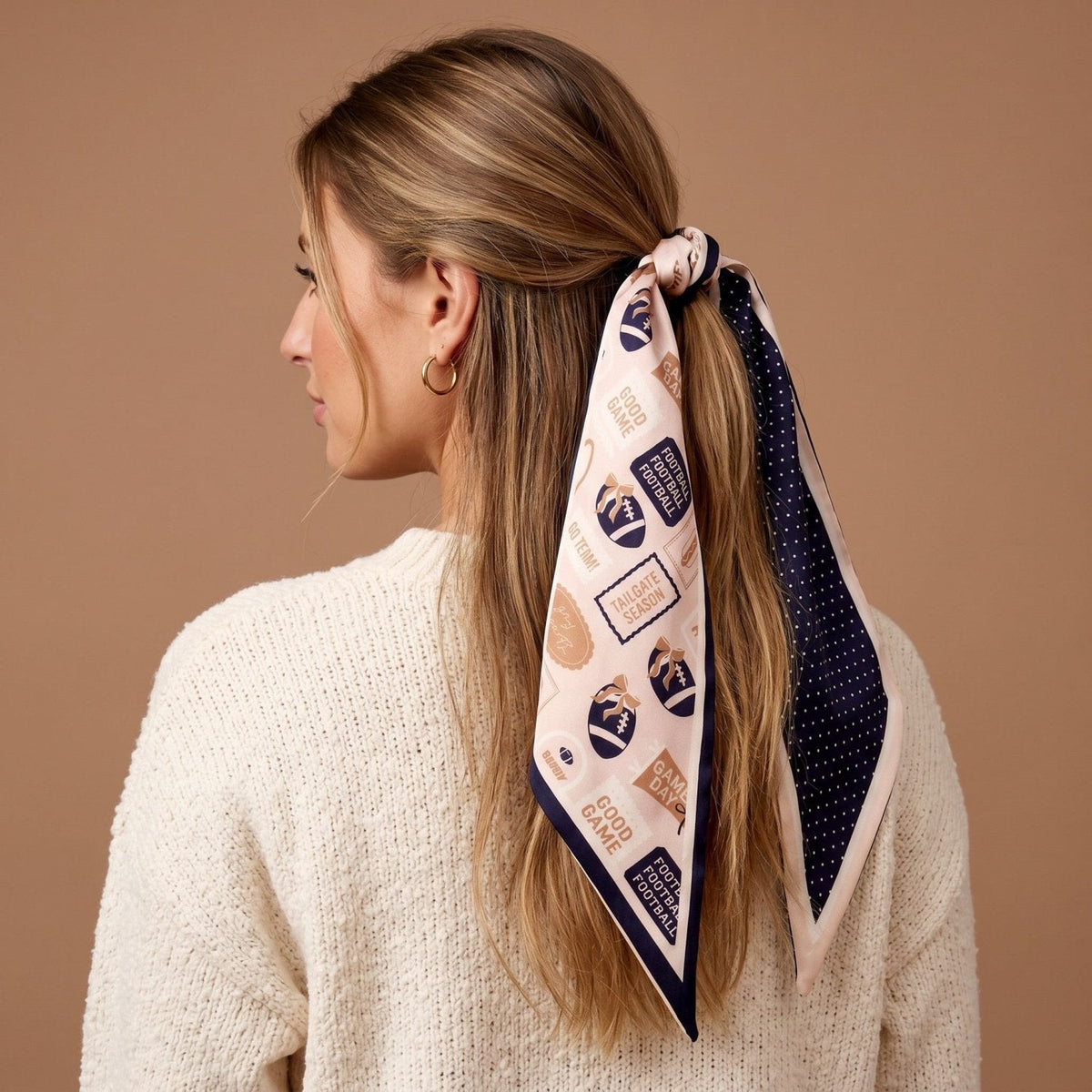 Twirl & Tie Scarf Accessory, A red and white gingham satin scarf tied in a knot, showing a red polka dot pattern on the reverse side of the tails.