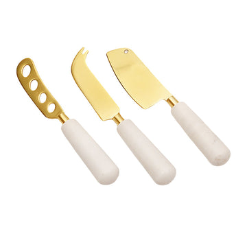 Calandiva Cheese Knife Set with White Stone Handles, Three cheese knives with gold-finish blades and white stone handles, laid side by side on a white background.