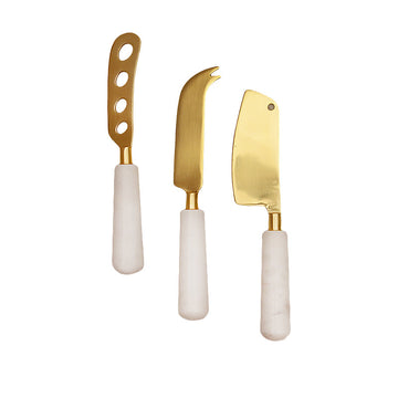 Calandiva Cheese Knife Set with White Stone Handles, Three cheese knives with gold-finish blades and white stone handles, laid side by side on a white background.