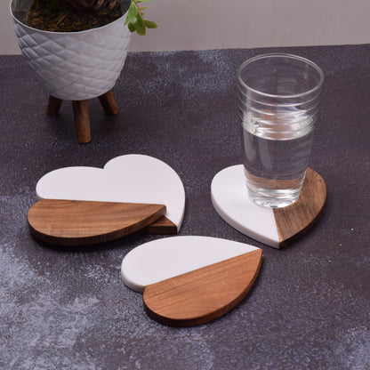 Zara Heart Coaster, A heart-shaped coaster, half natural wood and half white resin, stood upright to show the wood-and-resin split.