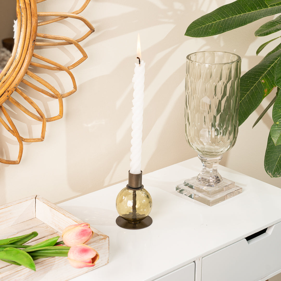 Kefi Olive Glass Round Candle Holder, A round olive glass candle holder with a textured, faceted surface and a dark bronze metal taper cup on top, set on a flat round base, shown alone.