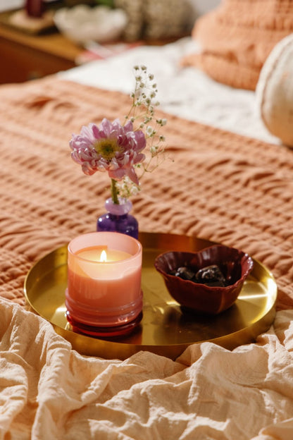 Stack 7 oz Candle, A blush pink glass candle with a maroon stacking lid, labeled Saffron Rose Soy Wax Candle, 7 oz.