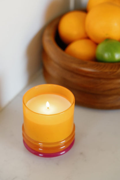 Stack 7 oz Candle, A blush pink glass candle with a maroon stacking lid, labeled Saffron Rose Soy Wax Candle, 7 oz.