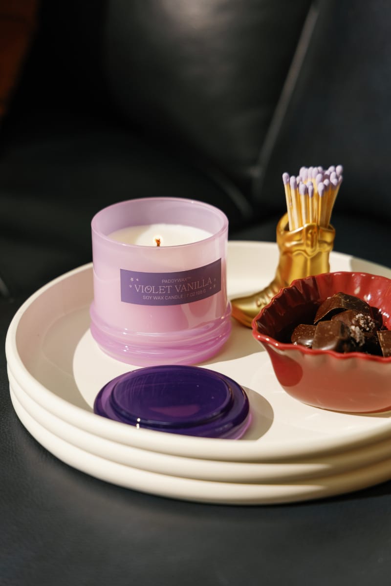 Stack 7 oz Candle, A blush pink glass candle with a maroon stacking lid, labeled Saffron Rose Soy Wax Candle, 7 oz.