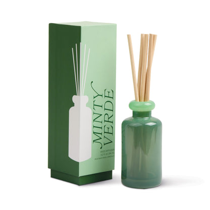 Stack 3.2 oz Diffuser, A maroon glass reed diffuser bottle with pink topped reeds standing next to its packaging box labeled Saffron Rose.