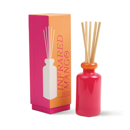 Stack 3.2 oz Diffuser, A maroon glass reed diffuser bottle with pink topped reeds standing next to its packaging box labeled Saffron Rose.