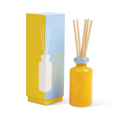 Stack 3.2 oz Diffuser, A maroon glass reed diffuser bottle with pink topped reeds standing next to its packaging box labeled Saffron Rose.