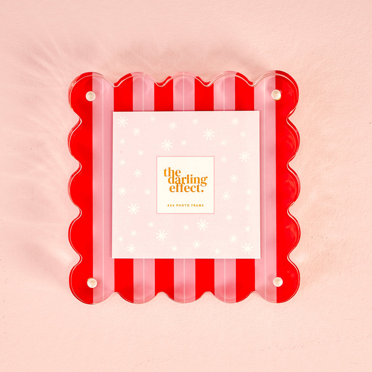 A square acrylic picture frame with a red and pink striped scalloped edge and pearl-style corner dots, holding a 4x4 photo card.