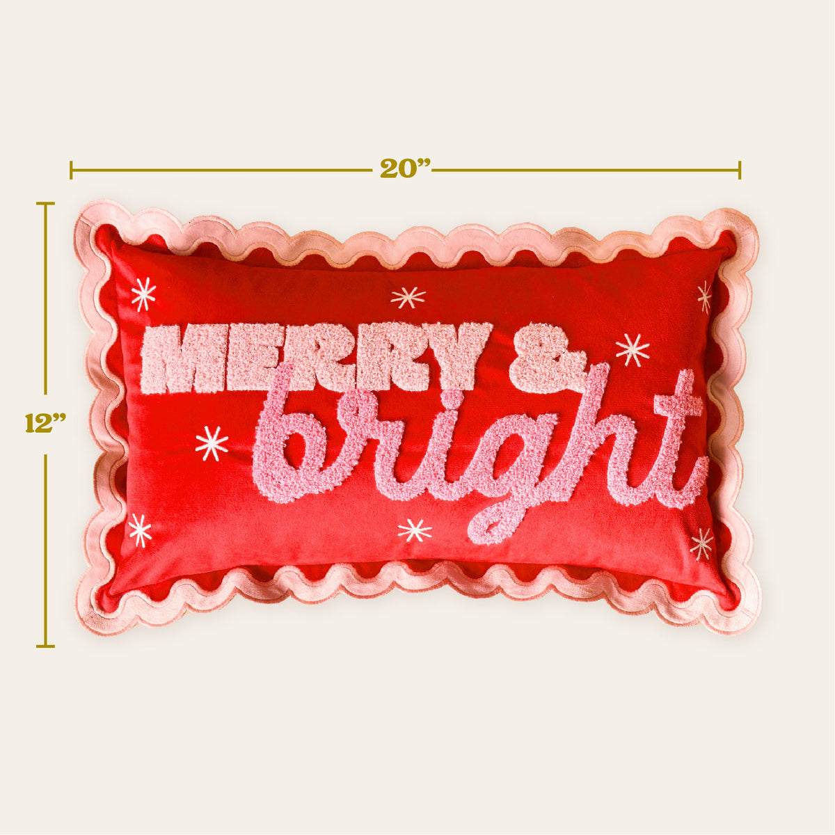 Scalloped Rectangle Throw Pillow, A blush pink lumbar pillow with three tufted green Christmas trees tied in red bows and a pink scalloped edge, set on a boucle chair.