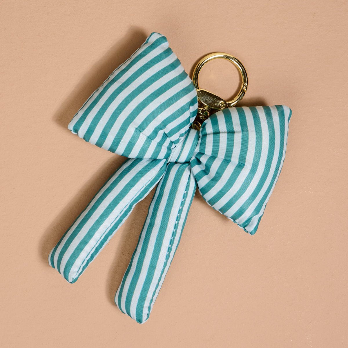 Puffy Bow Bag Charm, A green, red, and white plaid puffy bow shaped bag charm with a gold-toned keyring clasp.