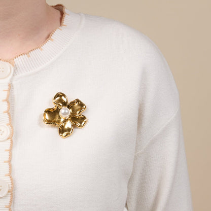 Timeless Brooch, A small gold brooch pin shaped like a teddy bear and covered edge to edge in clear rhinestones, with a gold bow at its neck, shown on a tan background.