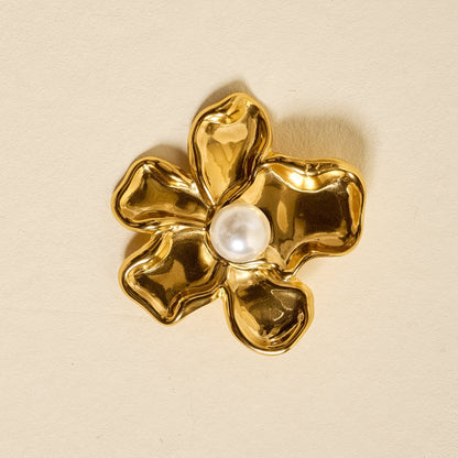 Timeless Brooch, A small gold brooch pin shaped like a teddy bear and covered edge to edge in clear rhinestones, with a gold bow at its neck, shown on a tan background.