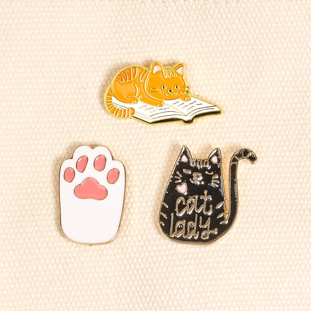 Enamel Pin Pack, A boxed set of three gold enamel pins in the Latte Love design, a coffee cup, a teddy bear, and a pink bow.