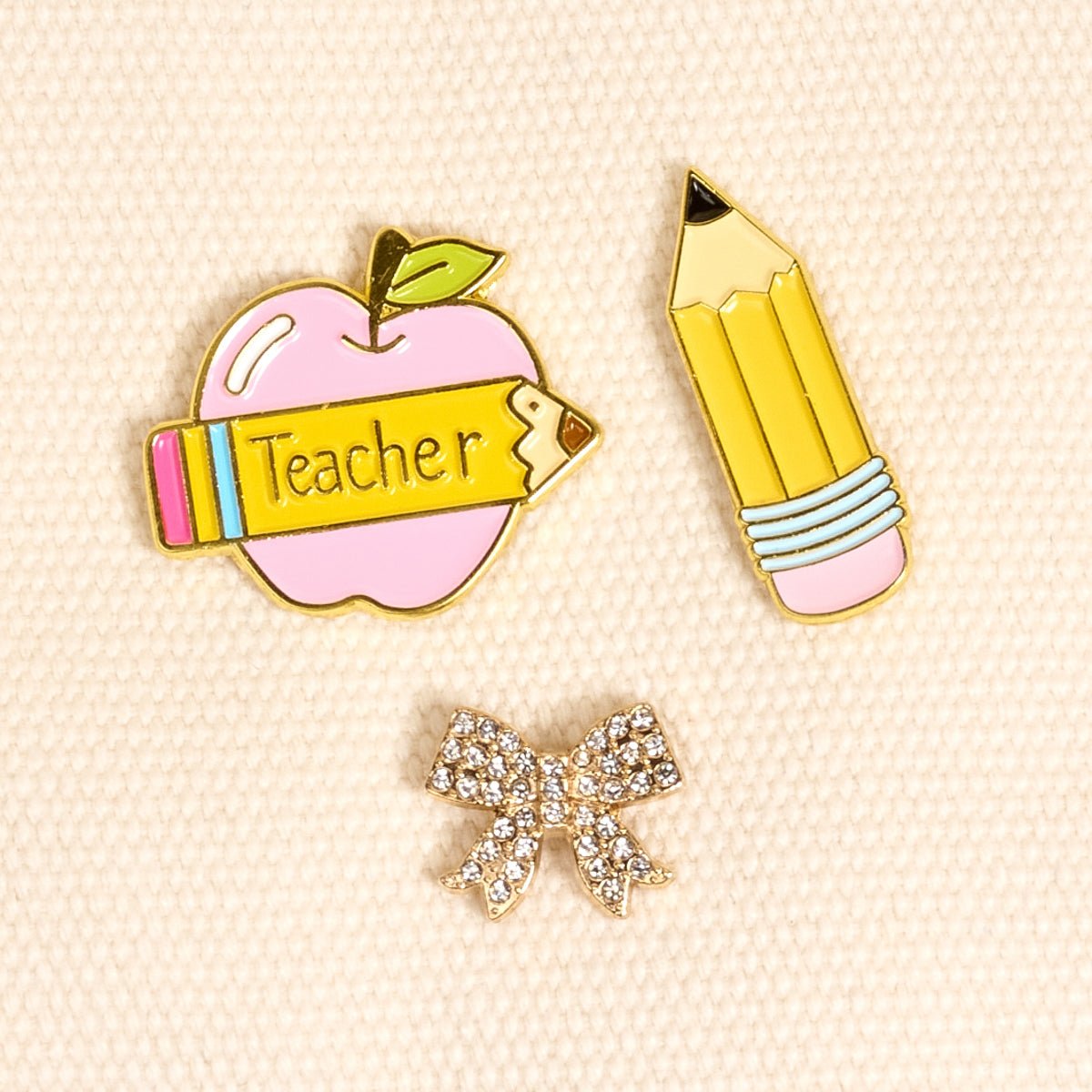 Enamel Pin Pack, A boxed set of three gold enamel pins in the Latte Love design, a coffee cup, a teddy bear, and a pink bow.