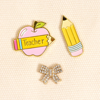 Enamel Pin Pack, A boxed set of three gold enamel pins in the Latte Love design, a coffee cup, a teddy bear, and a pink bow.