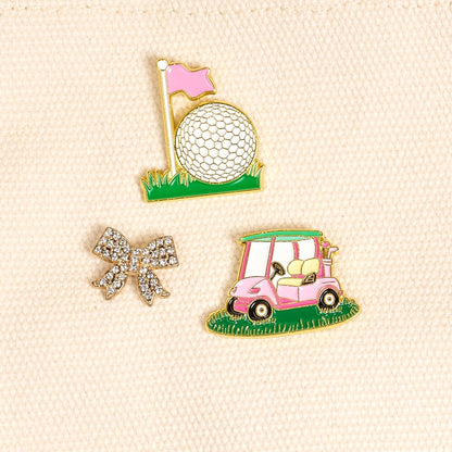 Enamel Pin Pack, A boxed set of three gold enamel pins in the Latte Love design, a coffee cup, a teddy bear, and a pink bow.