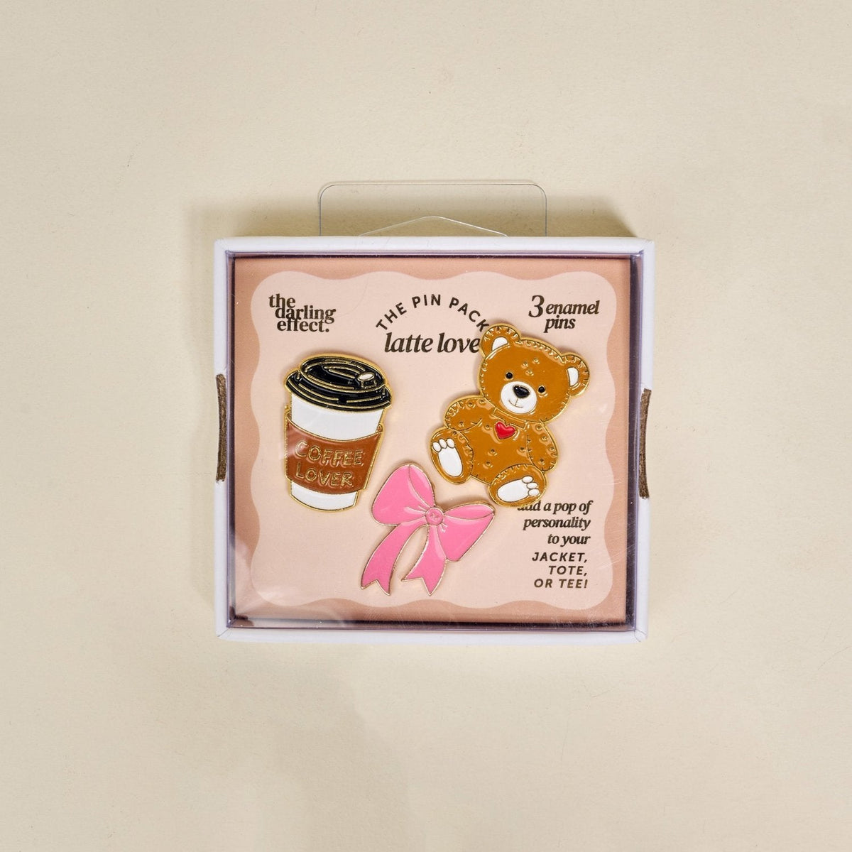 Enamel Pin Pack, A boxed set of three gold enamel pins in the Latte Love design, a coffee cup, a teddy bear, and a pink bow.