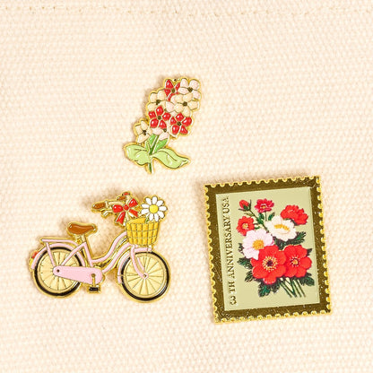 Enamel Pin Pack, A boxed set of three gold enamel pins in the Latte Love design, a coffee cup, a teddy bear, and a pink bow.