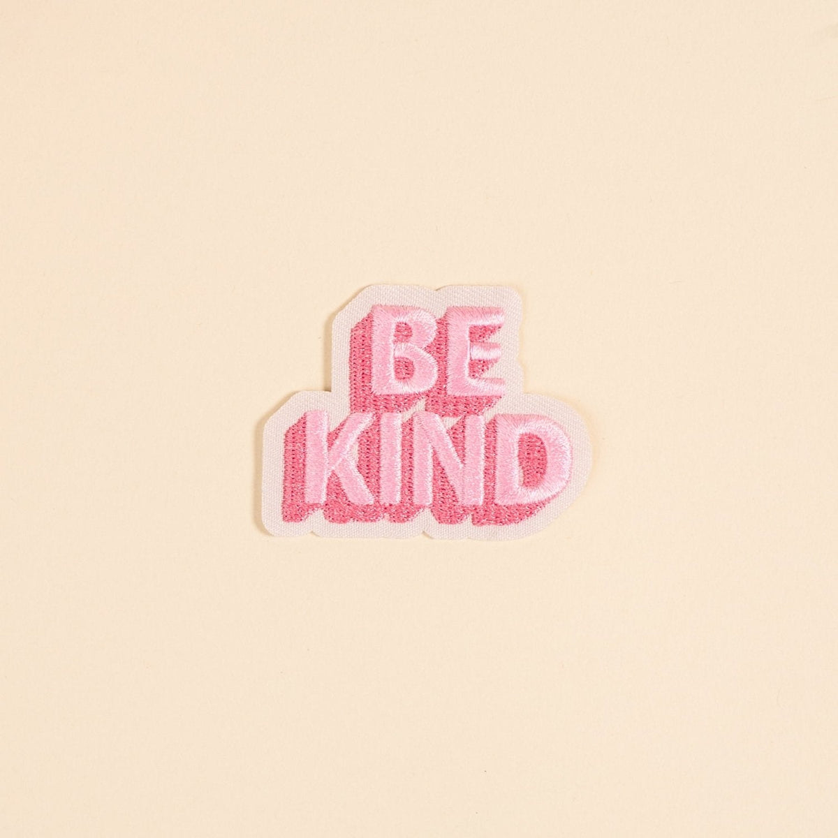 Mix & Match Iron-On Patch, A pink Be Kind patch on its patch card, with BE KIND spelled out in bold pink lettering.