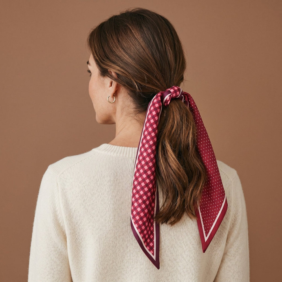 Twirl & Tie Scarf Accessory, A red and white gingham satin scarf tied in a knot, showing a red polka dot pattern on the reverse side of the tails.