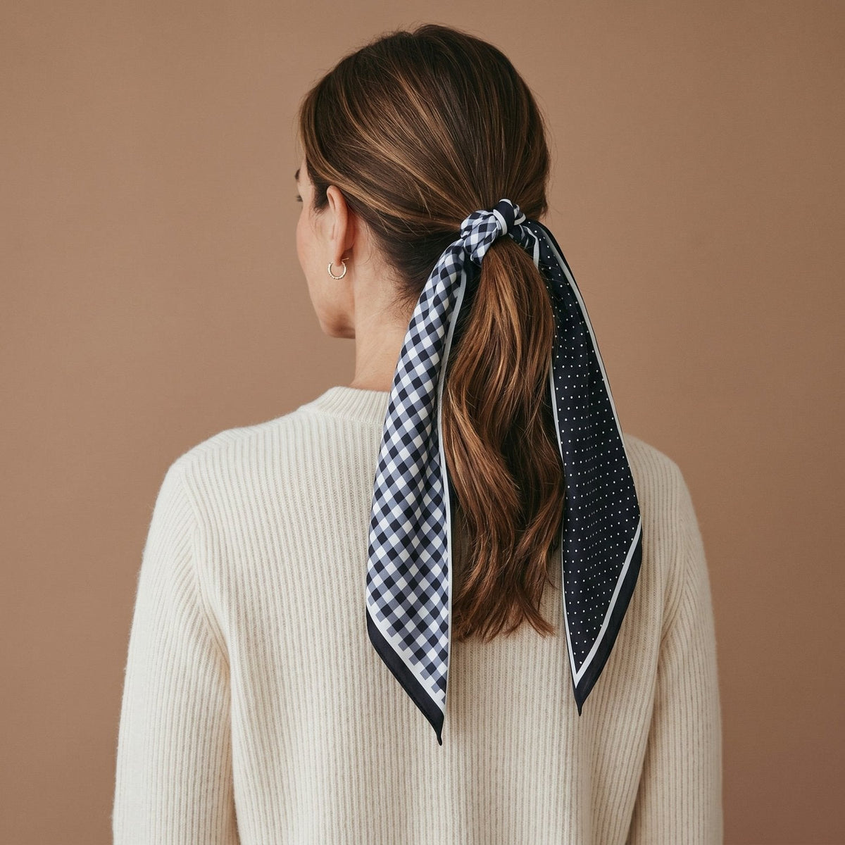 Twirl & Tie Scarf Accessory, A red and white gingham satin scarf tied in a knot, showing a red polka dot pattern on the reverse side of the tails.