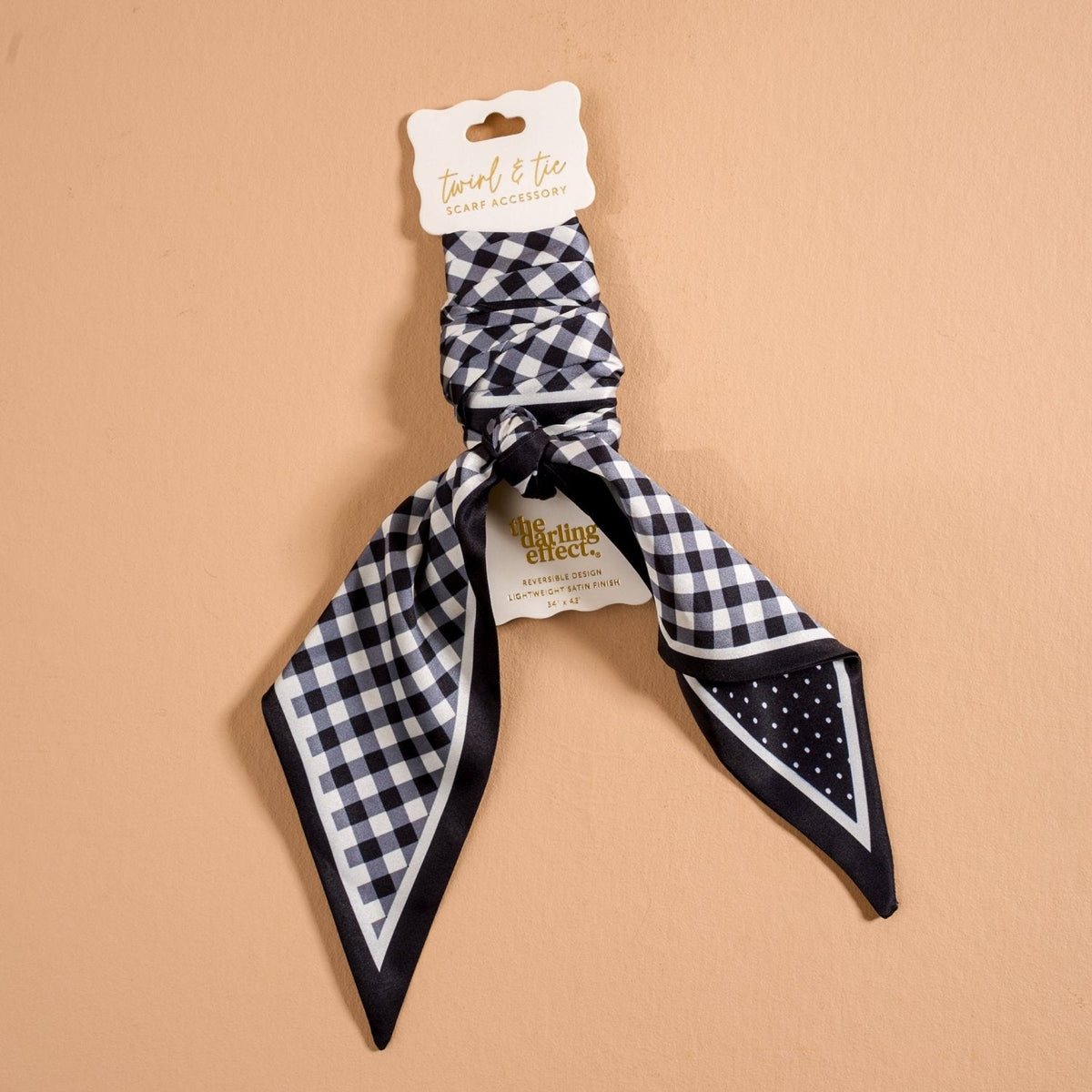 Twirl & Tie Scarf Accessory, A red and white gingham satin scarf tied in a knot, showing a red polka dot pattern on the reverse side of the tails.