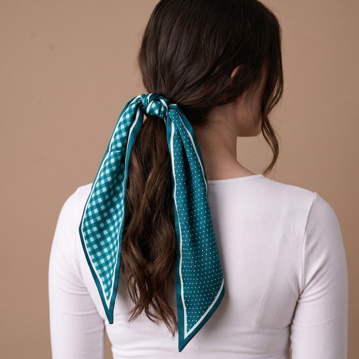 Twirl & Tie Scarf Accessory, A red and white gingham satin scarf tied in a knot, showing a red polka dot pattern on the reverse side of the tails.