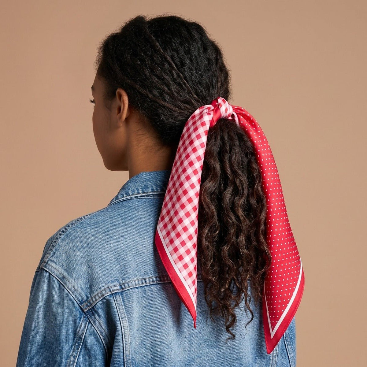 Twirl & Tie Scarf Accessory, A red and white gingham satin scarf tied in a knot, showing a red polka dot pattern on the reverse side of the tails.