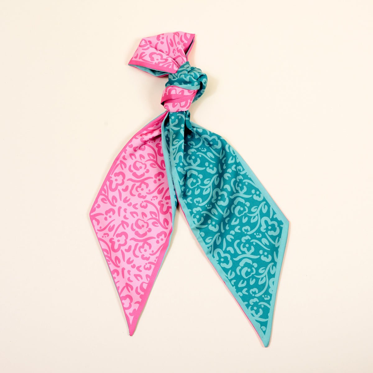 Twirl & Tie Scarf Accessory, A red and white gingham satin scarf tied in a knot, showing a red polka dot pattern on the reverse side of the tails.