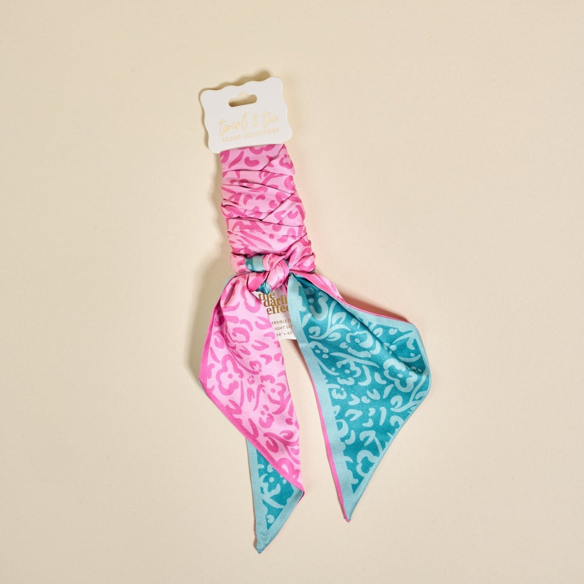 Twirl & Tie Scarf Accessory, A red and white gingham satin scarf tied in a knot, showing a red polka dot pattern on the reverse side of the tails.