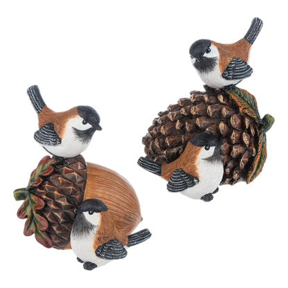 Acorn and Pinecone Bird Figurine, Two figurines, each with a pair of black-capped birds with rust-colored backs perched on an acorn and pinecone or on a large pinecone with autumn leaves.