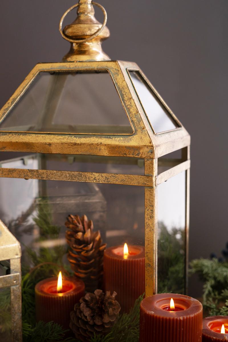 Antique Gold Christmas Lantern, Two antique gold metal lanterns with glass panels, one large and one small.