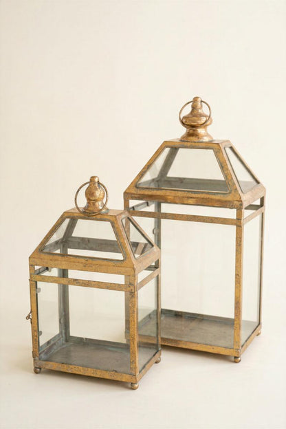 Antique Gold Christmas Lantern, Two antique gold metal lanterns with glass panels, one large and one small.