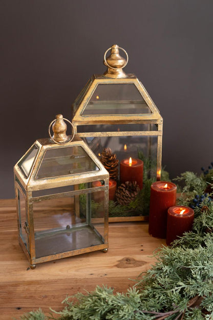 Antique Gold Christmas Lantern, Two antique gold metal lanterns with glass panels, one large and one small.
