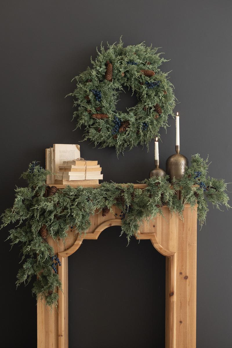 Artificial Juniper Christmas Garland with Berries, A faux juniper garland with red berries and pinecones laid out in a line.