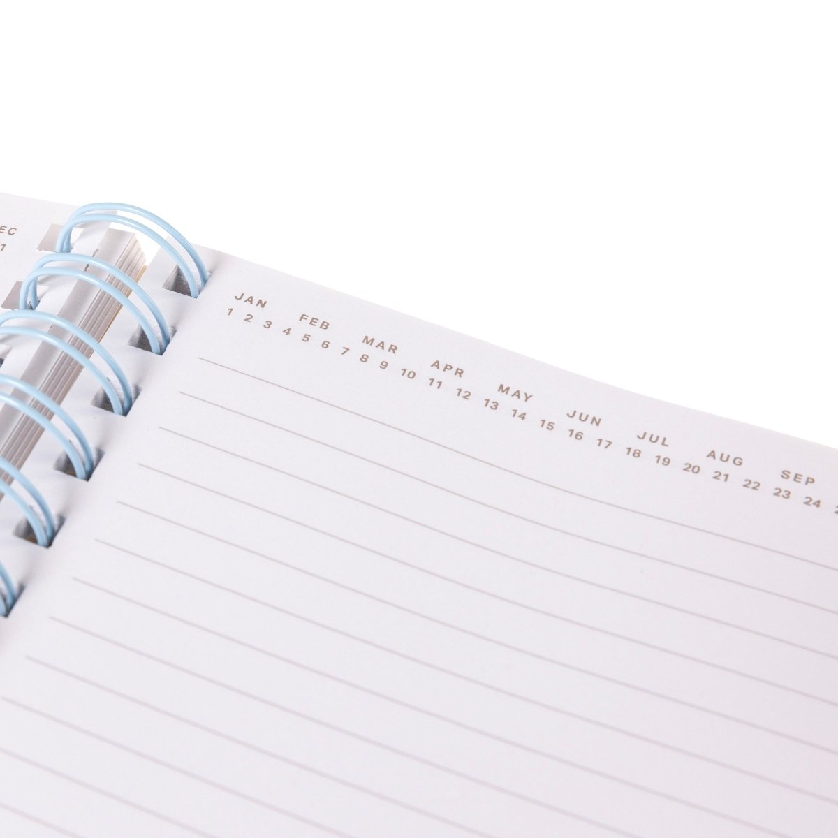 At Capacity Everyday Journal, A cream spiral-bound journal covered in rainbow smiley faces with the words i'm at capacity in colorful lettering at the center.