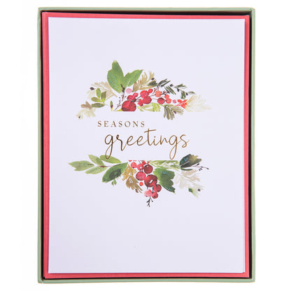 Season's Greetings Holiday Boxed Cards, A Christmas card with a watercolor holly and berry design and gold foil Seasons Greetings script, shown with its red envelope.